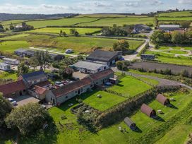 An outdoor area with buildings and camping pods at Mini pod Staintondale near Burniston