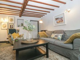 A living room with a sofa, armchair and coffee table at Elm Cottage in Moreton-In-Marsh