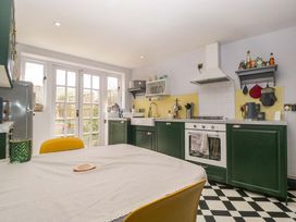 A kitchen with a table and chairs at Elm Cottage in Moreton-In-Marsh