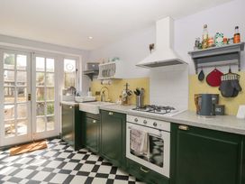 A kitchen with a sink and stove at Elm Cottage in Moreton-In-Marsh