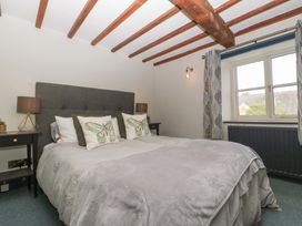 A bedroom with a bed and lamps at Elm Cottage in Moreton-In-Marsh