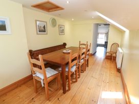 A dining room with a wooden table and chairs at The Cottage St. Ives