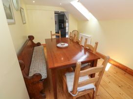 A dining room with a table and chairs at The Cottage in St. Ives