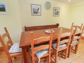 A dining room with a table and chairs at The Cottage in St. Ives