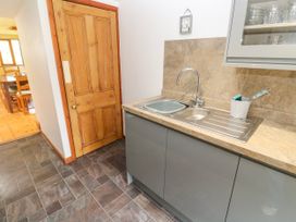 A kitchen with a sink and cupboard at The Cottage in St. Ives