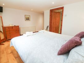 A bedroom with a bed and dresser at The Cottage in St. Ives