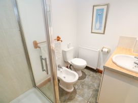 A bathroom with a shower, toilet, and bidet at The Cottage in St. Ives