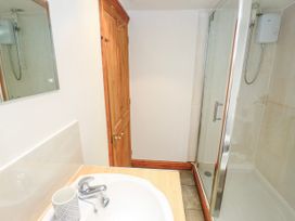 A bathroom with a sink and shower at The Cottage St. Ives