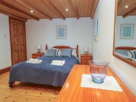 A bedroom with a bed and bedside table at The Cottage in St. Ives