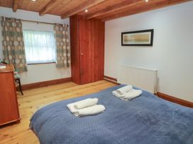 A bedroom with a bed and towels folded on top at The Cottage in St. Ives