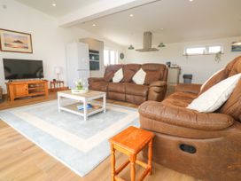 A living room with two sofas and a coffee table at Swallows Nest in St. Ives