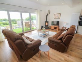 A living room with a sofa and a coffee table at Swallows Nest in St. Ives