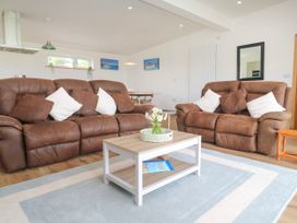 A living room with sofas and a coffee table at Swallows Nest in St. Ives