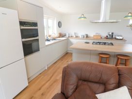 A kitchen with appliances and a countertop at Swallows Nest in St. Ives