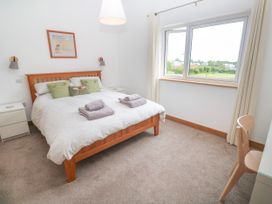 A bedroom with a bed and towels on it at Swallows Nest in St. Ives