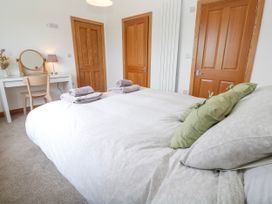 A bedroom with a bed and desk at Swallows Nest St. Ives