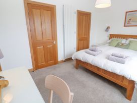 A bedroom with a bed and towels on it at Swallows Nest in St. Ives