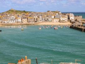 A coastal view with boats in the water at Swallows Nest in St. Ives