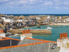 A view of buildings and boats by the water at Swallows Nest in St. Ives