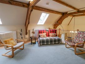 A living room with a sofa, armchairs and a coffee table at Yr Hen Ysgoldy