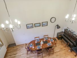 A dining room with a table set for dinner at Yr Hen Ysgoldy