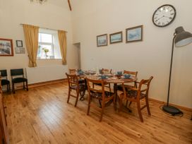 A dining room with a table set for meals at Yr Hen Ysgoldy