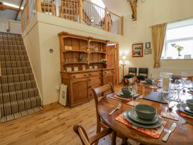 A dining room with a wooden table and chairs at Yr Hen Ysgoldy