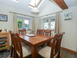 A dining room with a wooden table and chairs at Wren Cottage in Ross-on-Wye