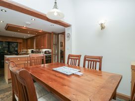 A dining room with a wooden table and chairs at Wren Cottage in Ross-on-Wye