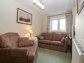 A living room with a sofa and armchair at Wren Cottage in Ross-on-Wye