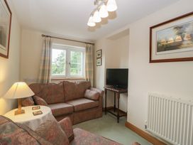 A living room with a sofa and television at Wren Cottage in Ross-on-Wye
