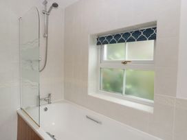 A bathroom with a bath and shower at Wren Cottage in Ross-on-Wye