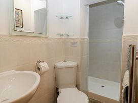 A bathroom with a sink, toilet, and shower at Wren Cottage in Ross-on-Wye