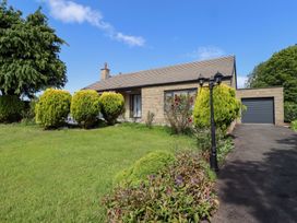 A house with greenery and pathway at Rose Cottage Dunstan near Embleton