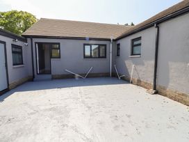 An outdoor area with a building and windows at Rose Cottage in Dunstan near Embleton