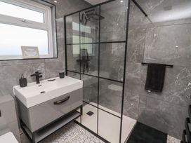A bathroom with a shower and wash basin at Rose Cottage in Dunstan near Embleton