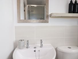 A bathroom with a basin and toilet at Poldam St Austell