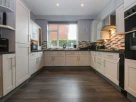 A kitchen with countertops and cabinets at Ty Llwyd in Llandudno