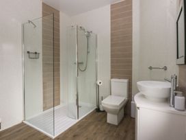 A bathroom with shower, toilet and sink at Ty Llwyd in Llandudno