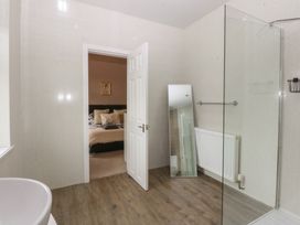 A bathroom with a bathtub and shower at Ty Llwyd Llandudno