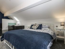 A bedroom with a bed and bathtub at Ty Llwyd in Llandudno