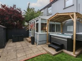 A garden with a hot tub and patio at Ty Llwyd in Llandudno