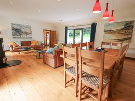 A living room with a sofa and dining area at Bracken Ground in Coniston