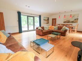A living room with a sofa and a dining table at Bracken Ground in Coniston