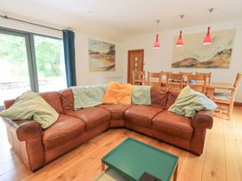 A living room with a sofa and dining area at Bracken Ground in Coniston