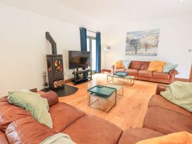 A living room with a fireplace and television at Bracken Ground in Coniston