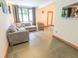 A living room with a sofa and armchair at Bracken Ground in Coniston