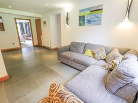 A living room with a sofa and wall art at Bracken Ground in Coniston