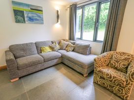A living room with a sofa and armchair at Bracken Ground in Coniston
