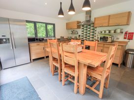 A kitchen with wooden furniture and appliances at Bracken Ground in Coniston